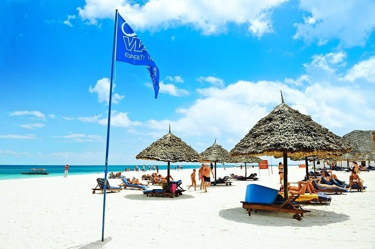 Sun loungers and thatched parasols on the beach at Kendwa, Zanzibar