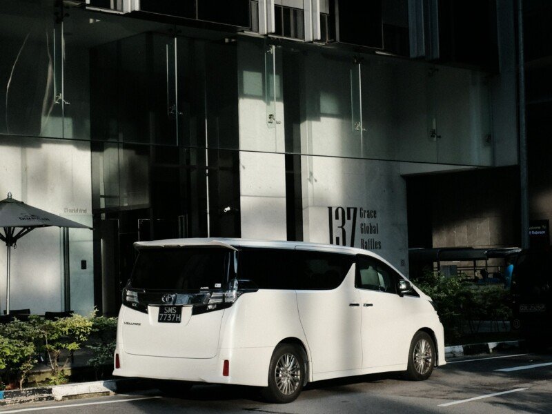 Private vehicle waiting at a hotel entrance