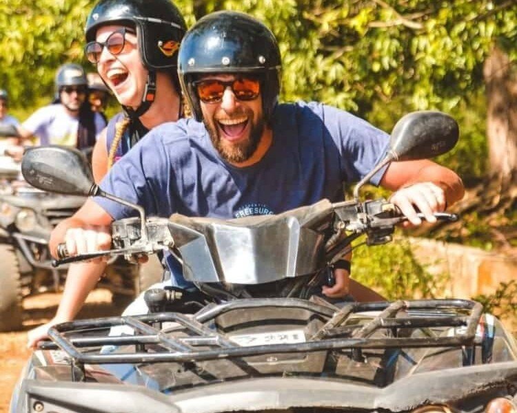 Two guests laughing on a quad bike during a Zanzibar quad bike tour